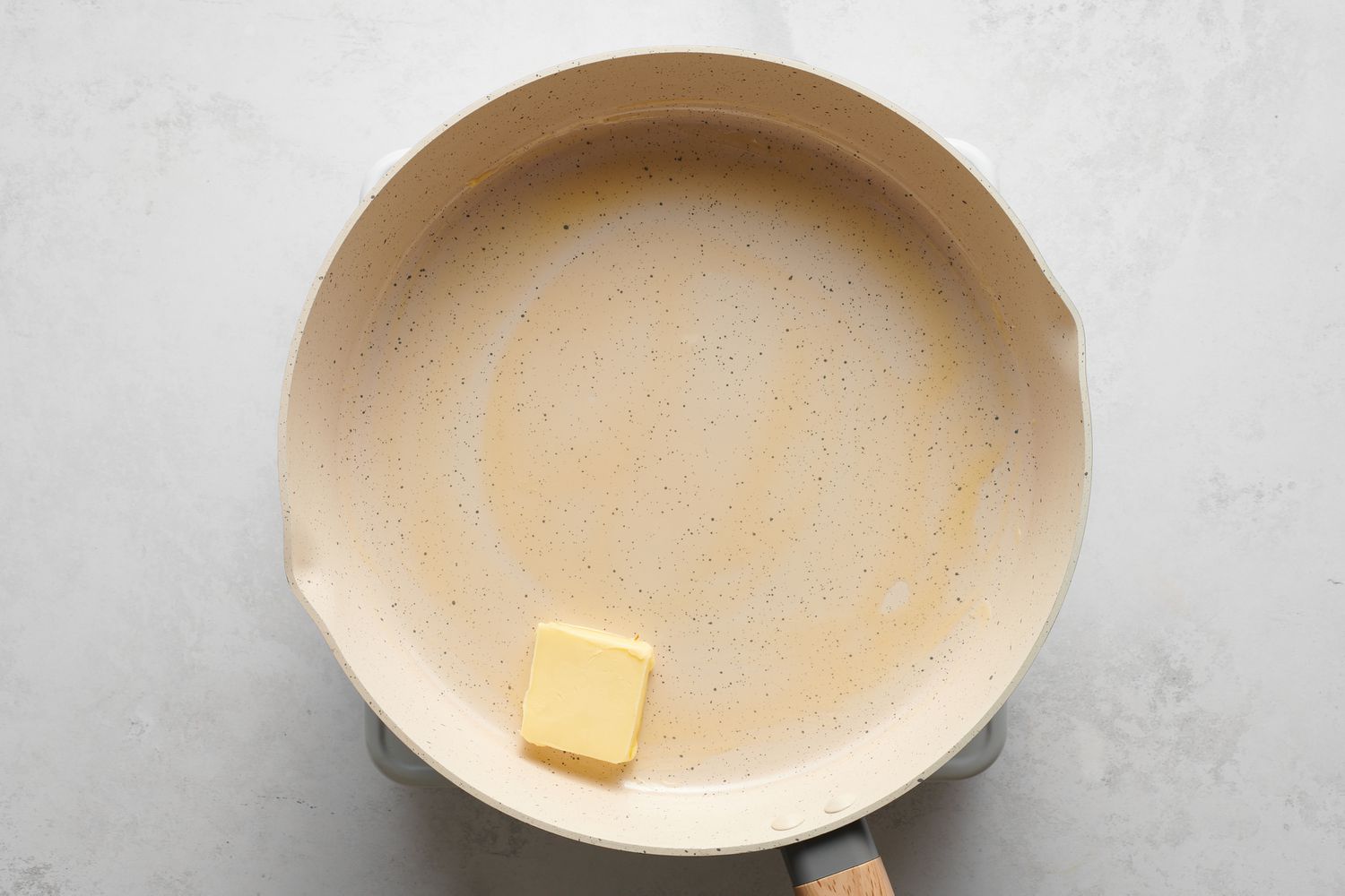 A pad of butter in a large skillet